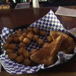 a basket of fried donuts and a sandwich
