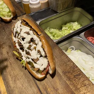 two sub sandwiches on a cutting board