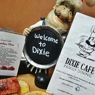 a menu and a statue of a chef