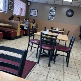 people sitting at tables in a restaurant