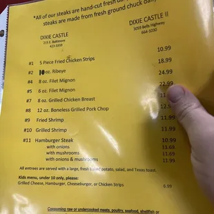 a hand holding a menu