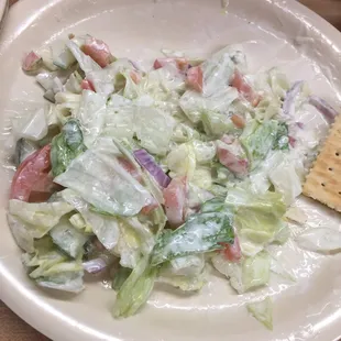 a plate of salad and crackers