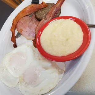 Sausage, bacon, eggs, and grits on the sampler platter.