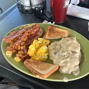 Biscuits and Gravy with scrambled eggs, bacon, home fried potatoes (w optional onions) and toast.