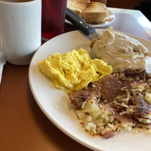 Chicken fried steak , hashbrowns, scrambled eggs, rye toast, coffee, cranberry juice