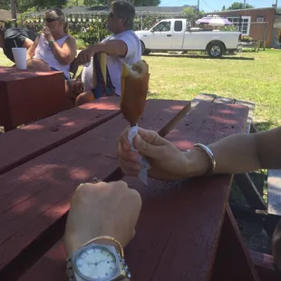 two people sitting at a picnic table