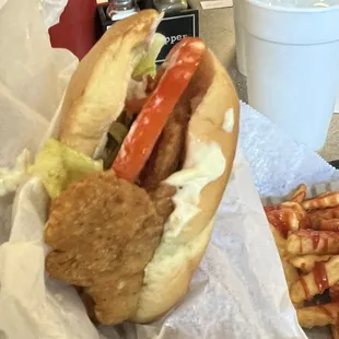 The crispy chicken sandwich loaded with lettuce and tomatoes. It comes wrapped tightly in a pocket!