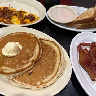 Bacon and cheese omelette, short stack of pancakes and sides