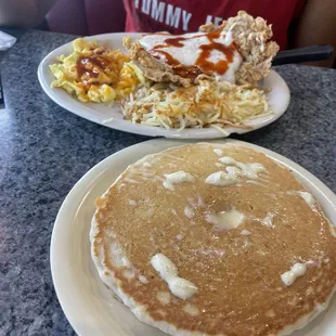 Country fried steak w/ scrambled eggs and hash browns.  Pancake on the side w/ butter on top!