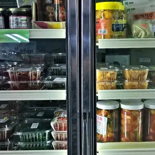 Pickled ingredients, kimchi, spicy fried squid, fresh cut fruits. Very fresh looking!