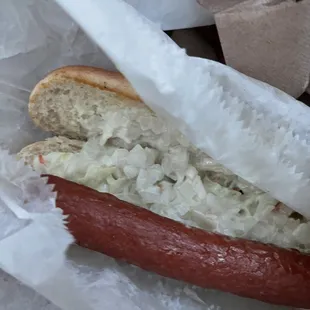 a hot dog with sauerkraut on a bun