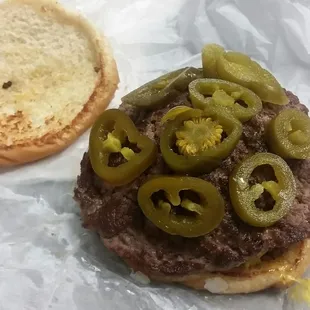 a hamburger with pickles on it