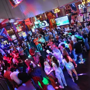 a crowded bar with neon lights