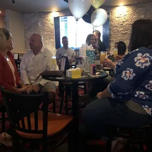 a group of people sitting around a table
