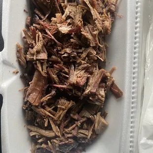 shredded beef in a styrofoam container