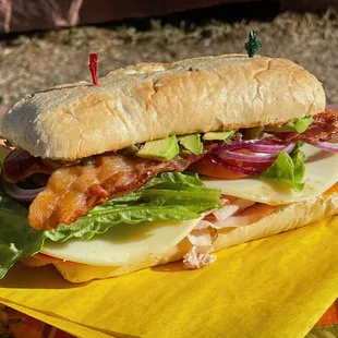 a bacon, lettuce, tomato, and cheese sandwich