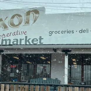 Another storefront view with snow beginning to fall