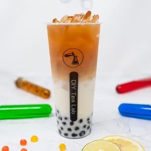 a glass of bubble tea with a lemon slice