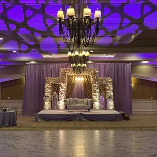 2 moving head lights projected on the wall / ceiling to match the uplights and overall color theme.