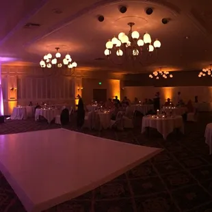 Uplighting with contrast colors to highlight the bride and groom's table