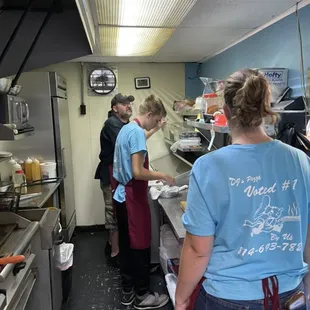 a group of people in a kitchen