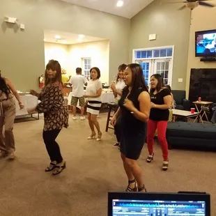 a group of people dancing in a living room