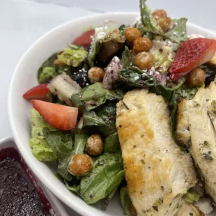 a salad with chicken and vegetables