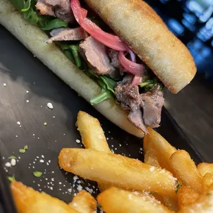 a steak sandwich and french fries