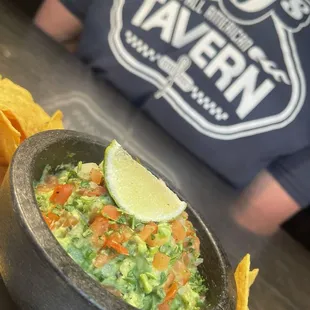 a bowl of guacamole and chips