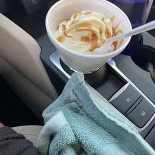 a cup of ice cream with caramel sauce