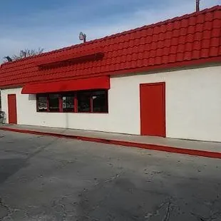 a red roof and white building