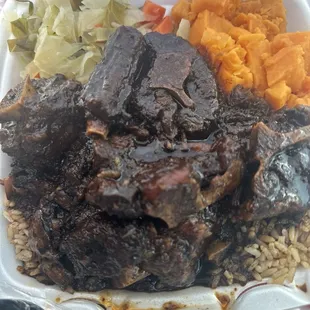 Oxtails Candied Yams Cabbage Rice and Peas