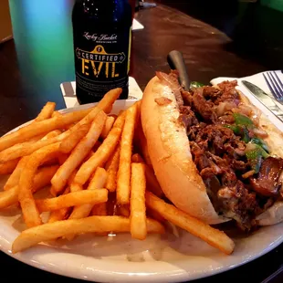 Philly Cheesesteak and fries, with a Certified Evil from Lucky Bucket.