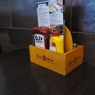 a wooden box with condiments and condiments