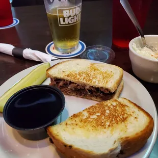 a sandwich and a pickle on a plate