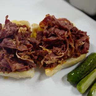 Small boiled pastrami with a half sour pickles.