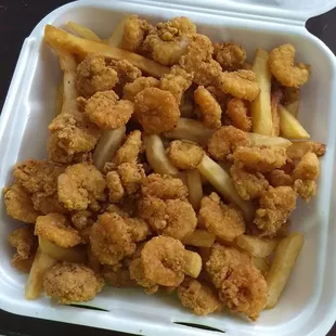 a tray of fried chicken and fries