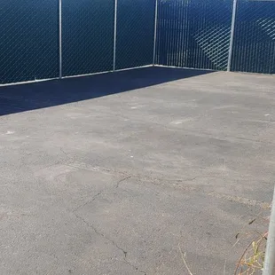 a tennis court with a chain link fence