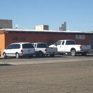 a row of trucks parked in front of a building