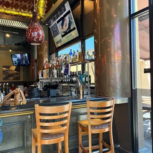 a bar with wooden chairs