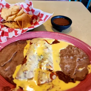 Brisket filled enchiladas w/ con Carne and queso and chips / salsa! Yummmmmmm!