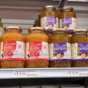 a shelf full of jars of jams