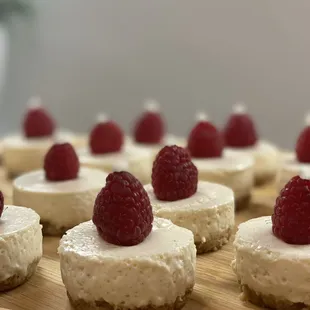 mini cheesecakes with raspberries on top