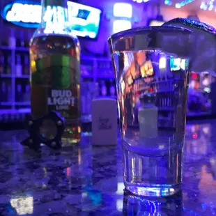 a shot of a drink with a lime garnish