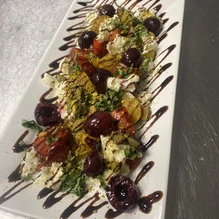 Heirloom Tomato salad with boozy cherries, mozzarella, basil and balsamic glaze.  A seasonal favorite.