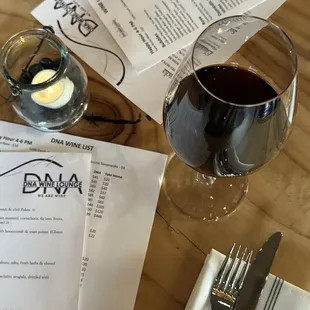 a glass of wine and a menu