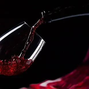 red wine being poured into a wine glass