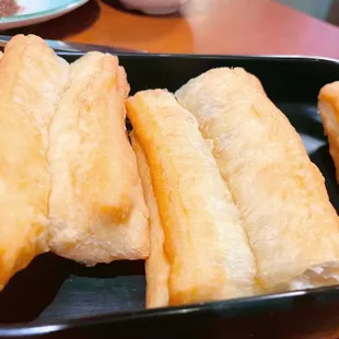 a tray of fried breadsticks