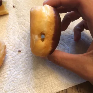 a hand holding a donut