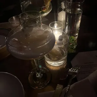 a close up of a table with glasses and a candle